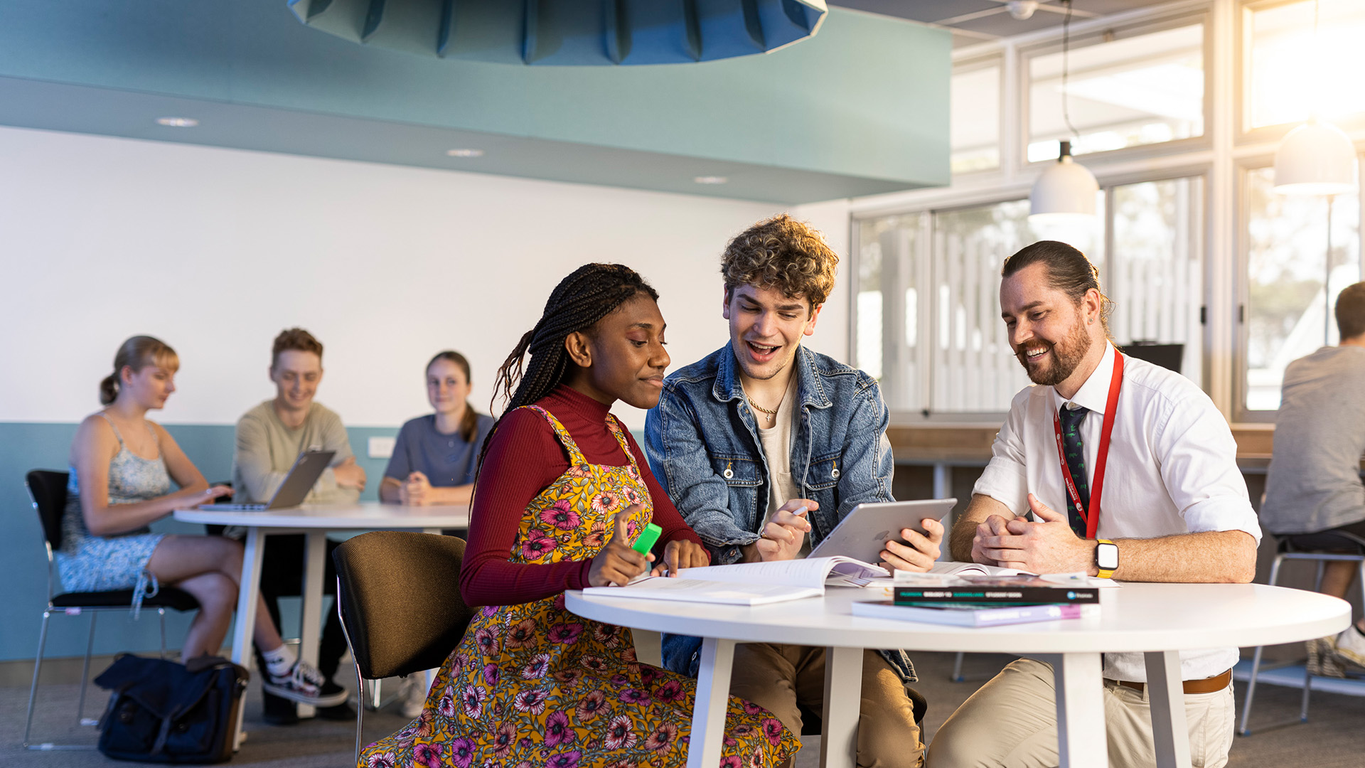 aida with fellow students at a table learning